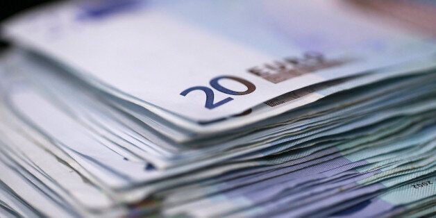 A stack of twenty euro banknotes are arranged for a photograph inside a Travelex store, operated by Travelex Holdings Ltd., in London, U.K., on Monday, Jan. 12, 2015. The euro approached a nine-year low against the dollar as European Central Bank officials fueled speculation the institution will start a program of government-bond buying as early as next week to stave off deflation. Photographer: Simon Dawson/Bloomberg via Getty Images