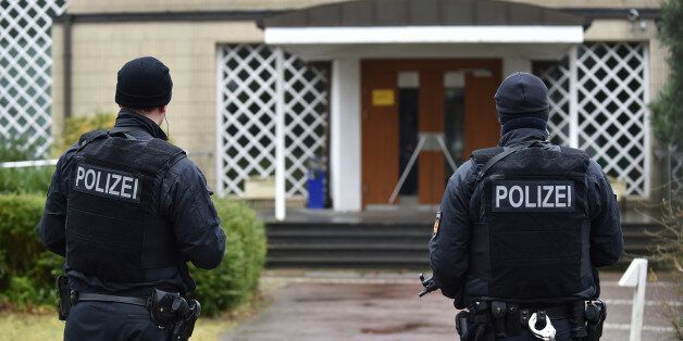 Police guard the entrance of a synagogue in Bremen, Germany, Sunday March 1, 2015. Police in the German city of Bremen warned Saturday of a potential danger from Islamic extremists there and stepped up security measures. Police said they stepped up their presence in the city and, as a precaution, increased security for the Jewish community. They said Saturday evening, several hours after issuing the warning, that they had carried out searches on an unidentified suspect and at an Islamic culture center. One person was arrested, they added. (AP Photo/dpa,Carmen Jaspersen)