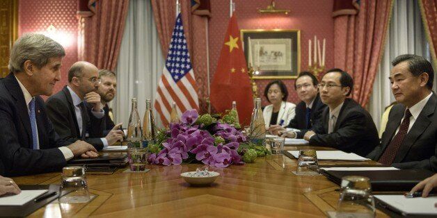 US Secretary of State John Kerry (L) and Chinese Foreign Minister Wang Yi (R) wait before the start of a meeting at the Beau Rivage Palace Hotel on March 29, 2015 in Lausanne, Switzerland, during Iran nuclear talks. The US and Chinese officials met while in Switzerland for negotiations on Iran's nuclear program. AFP PHOTO / POOL / BRENDAN SMIALOWSKI (Photo credit should read BRENDAN SMIALOWSKI/AFP/Getty Images)