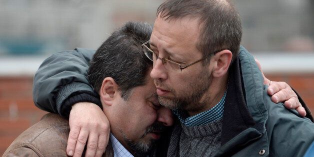 Workers from the Delphi factory, who lost two colleagues in the Germanwings flight crash, grieve after a minute of silence in Sant Cugat del Valles, near Barcelona, Spain, Wednesday, March 25, 2015. Germanwings Flight 9525 from Barcelona to Duesseldorf crashed Tuesday, April 24, in France. A total of 67 Germans, many Spaniards, and people from Australia, Japan, Israel, Turkey, Denmark and the Netherlands are believed to be among the 150 on board who died. (AP Photo/Manu Fernandez)