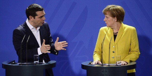German Chancellor Angela Merkel (R) and Greek Prime Minister Alexis Tsipras address a press conference following talks at the chancellery in Berlin, on March 23, 2015. AFP PHOTO / JOHN MACDOUGALL (Photo credit should read JOHN MACDOUGALL/AFP/Getty Images)