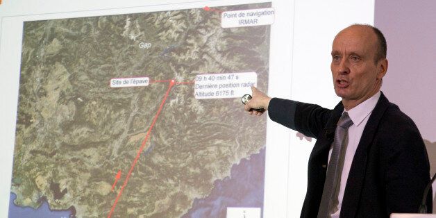 Remi Jouty, director of BEA, the French Air Accident Investigation Agency displays the trajectory of the crashed jetliner during a press conference at Le Bourget airport, north of Paris, Wednesday, March 25, 2015. The Germanwings jetliner crashed Tuesday in the French Alps. French investigators cracked open the badly damaged black box of the German jetliner on Wednesday and sealed off the rugged Alpine crash site where 150 people died when their plane on a flight from Barcelona, Spain, to Duess