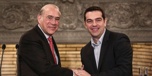 OECD Secretary General Jose Angel Gurria, left, shakes hands with Greek Prime Minister Alexis Tsipras after a news briefing in Athens on Wednesday, Feb. 11, 2015. Gurria met officials from Greece's new left-wing government who are seeking assistance in overhauling cost-cutting reforms imposed as part of an international bailout. Eurozone ministers are meeting Wednesday to discuss Greece's debt problem and efforts by Athens to restructure that debt. (AP Photo/Yorgos Karahalis)