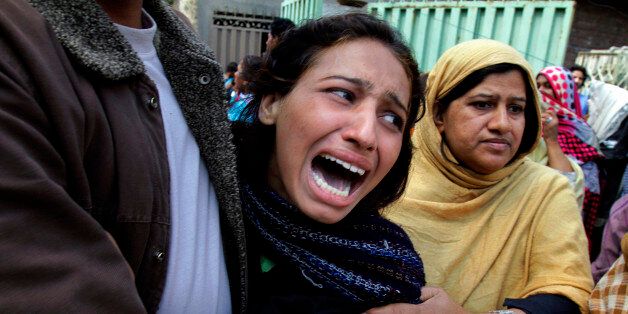 A Pakistani Christian woman mourns over a family member who was killed from a suicide bombing attack near two churches in Lahore, Pakistan, Sunday, March 15, 2015. Suicide bombers exploded themselves near two churches in the eastern city of Lahore on Sunday as worshippers were gathered inside, killing at least a dozen people, officials said, in the latest attack against religious minorities in the country. (AP Photo/K.M. Chaudary)
