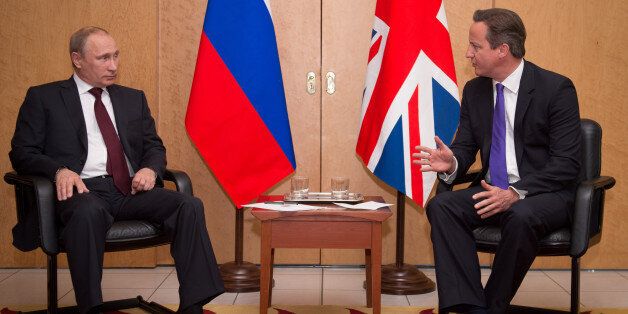 PARIS, FRANCE - JUNE 05: British Prime Minister David Cameron meets with Russian President Vladimir Putin (left) at Charles De Gaulle Airport on June 05, 2014 in Paris, France. The pair met as they travelled to France ahead of the 70th anniversary D-Day commemorations. (Photo by Stefan Rousseau - WPA Pool/Getty Images)