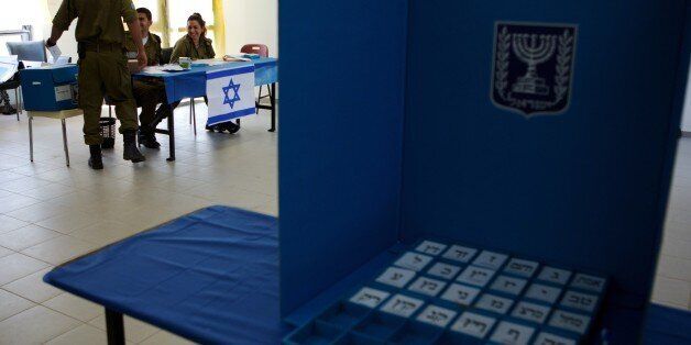 An Israeli soldier casts his vote at the Urim army base in the south of Israel near the border with the Gaza strip on March 15, 2015. Israeli soldiers started voting two days ahead of the March 17 general elections. There are 25 lists contesting the polls but under Israel's complex electoral system, the task of forming a new government does not automatically fall to the party that wins the largest number of votes. The winner will be the one who can succeed in cobbling together a coalition comman