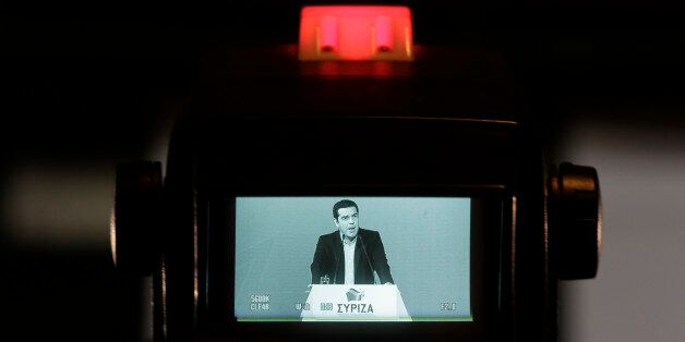 Greek Prime Minister and Syriza leader Alexis Tsipras is seen in a TV monitor as he delivers a speech at his party central committee in Athens, on Saturday, Feb. 28, 2015. Greece's new radical left government has no intention of seeking yet another bailout deal from international creditors and will spend coming months trying to ease the terms of its current commitments, the financially struggling country's prime minister said Friday.(AP Photo/Petros Giannakouris)