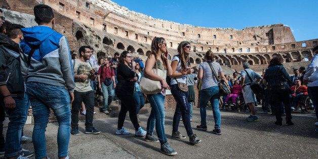 ROME, ITALY - NOVEMBER 07: Tourists take a tour inside the Colosseum for the re-opening of the hypogeum on November 7, 2013 in Rome, Italy. The Colosseum's hypogeum has been opened to the public again after being closed since October 21 due to a fragment of travertine becoming detached. (Photo by Giorgio Cosulich/Getty Images)