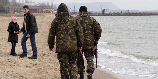 Local volunteers patrol the city beach in Mariupol, Donetsk region of Ukraine, Saturday, March 14, 2015. The bulk of continued unrest along the 485-kilometer (300-mile) front lines, between Ukraine's government forces and Russia-backed rebels, has been concentrated around the separatist stronghold of Donetsk but pitched battles are also taking place in the town of Shyrokyne, near the strategic port city of Mariupol. (AP Photo/Sergiy Vaganov)