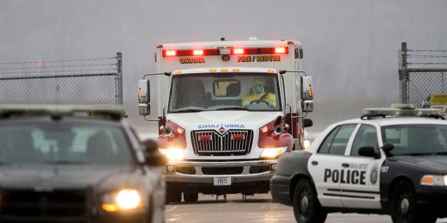 Police vehicles escort the ambulance carrying Dr. Martin Salia, a surgeon working in Sierra Leone who had been diagnosed with Ebola, as it heads from the airport to the Nebraska Medical Center in Omaha, Neb., Saturday, Nov. 15, 2014. Dr. Salia is the third Ebola patient at the Omaha hospital and the 10th person with Ebola to be treated in the U.S. (AP Photo/Nati Harnik)