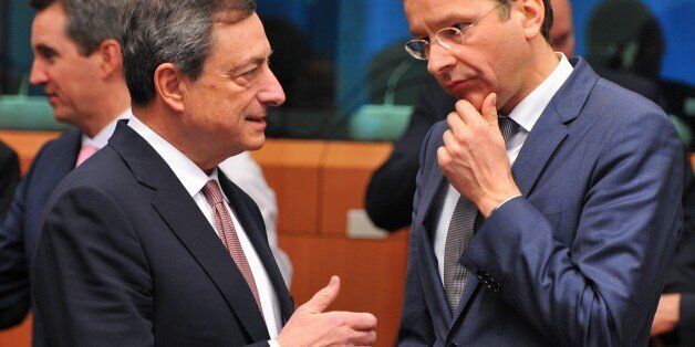 BRUSSELS, BELGIUM - MARCH 9: Eurogroup President and Dutch Finance Minister Jeroen Dijsselbloem (R) speaks with European Central Bank President Mario Draghi during a Eurogroup Finance Ministers meeting at the European Council in Brussels, March 9, 2015. (Photo by Dursun Aydemir/Anadolu Agency/Getty Images)