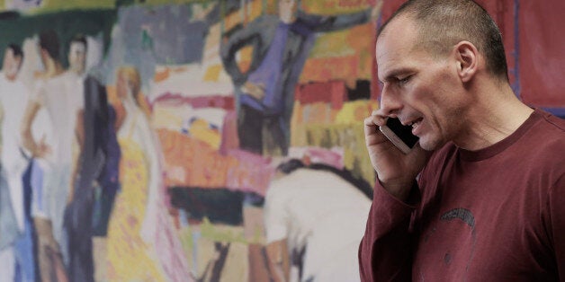 Greece's Finance Minister Yanis Varoufakis speaks on his phone at his office, in central Athens, on Saturday, Feb. 28, 2015. In an interview with the Associated Press Saturday, Varoufakis said that Greece intends to start discussions with its European partners and creditors on debt rescheduling in order to make the countryâs massive debt sustainable. (AP Photo/Petros Giannakouris)