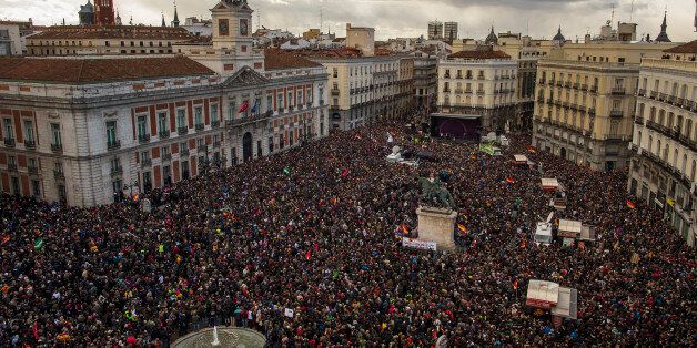 People gather in the main square of Madrid during a Podemos (We Can) party march in Madrid, Spain, Saturday, Jan. 31, 2015. Tens of thousands of people are marching through Madridâs streets in a powerful show of strength by Spainâs fledgling radical leftist party Podemos (We Can) which hopes to emulate the electoral success of Greeceâs Syriza party in elections later this year. (AP Photo/Andres Kudacki)