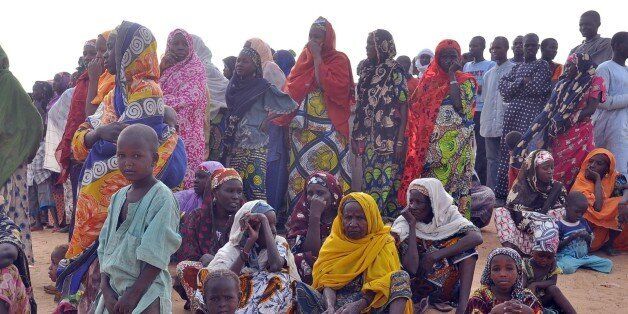Women and children fleeing from Boko Haram attacks sit at Kabalewa Refugees Camp, Diffa in Niger Republic, on March 13, 2015. Governor of northeastern Nigerian Borno State Kashim Shettima recently visited refugee camps where Nigerians fleeing from Boko Haram Islamists attacks are sheltered in Diffa province of Niger Republic. More than 13,000 people have been killed and some 1.5 million made homeless in the Boko Haram conflict since 2009, while recent cross-border attacks from Boko Haram bases in Nigeria on neighbouring countries have increased security fears. AFP PHOTO/OLATUNJI OMIRIN (Photo credit should read OLATUNJI OMIRIN/AFP/Getty Images)