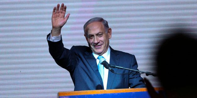 Israeli Prime Minister Benjamin Netanyahu greets supporters at the party's election headquarters In Tel Aviv. Wednesday, March 18, 2015. Exit polls from Israelâs national elections showed Prime Minister Benjamin Netanyahuâs Likud party nearly deadlocked with Isaac Herzogâs center-left Zionist Union. (AP Photo/Oded Balilty)