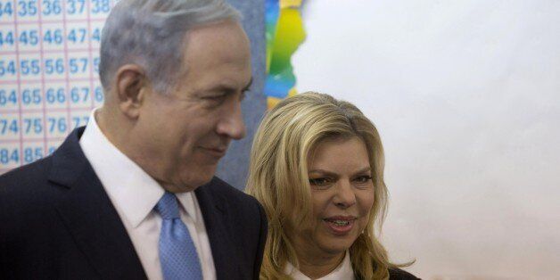 Israeli Prime Minister Benjamin Netanyahu stands with his wife Sara after voting during Israel's parliamentary elections in Jerusalem, on March 17, 2015. Israelis vote in an election expected to be a close-fought battle between the centre left and Prime Minister Benjamin Netanyahu, who ruled out a Palestinian state in a last-ditch appeal to the right. AFP PHOTO / POOL / SEBASTIAN SCHEINER (Photo credit should read SEBASTIAN SCHEINER/AFP/Getty Images)