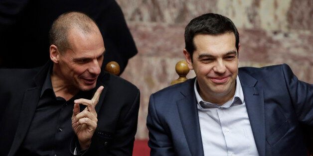 Greece's Prime Minister Alexis Tsipras, right, and Finance Minister Yanis Varoufakis chat during a Presidential vote in Athens, on Wednesday, Feb. 18, 2015. Greece's parliament elected Prokopis Pavlopoulos, a conservative law professor and veteran politician Wednesday as the country's new president, after he received support from the new left-wing government and main center-right opposition party. (AP Photo/Petros Giannakouris)