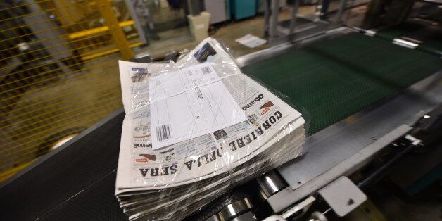 Newspapers are beign packed during the printing of the edition of the November 8, 2012 of the 'Corriere della Sera' with its frontpage on the results of the US presidential election on November 8, 2012 at the newspaper printing house in Milan. Founded in 1876, the Corriere della Sera is one of the main Italian daily newpspaper, with its offices located Via Solferino in Milan, in the same buildings since the beginning of the 20th century. AFP PHOTO / GIUSEPPE CACACE (Photo credit should read GIUSEPPE CACACE,GIUSEPPE CACACE/AFP/Getty Images)