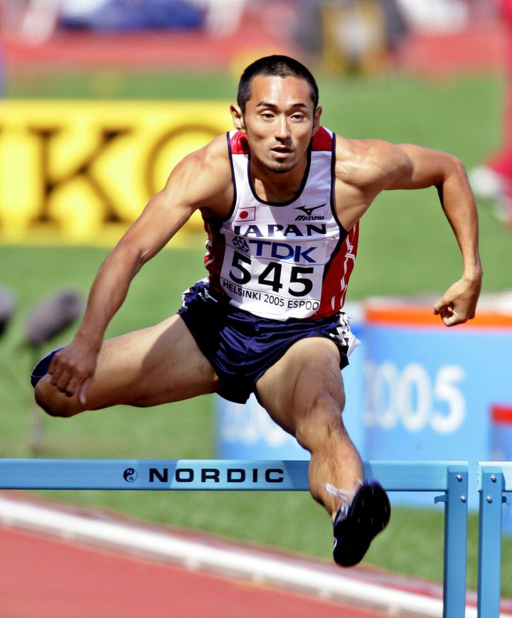 Dai Tamesue of Japan clears a hurdle in the fifth heat of the 400 metres men's hurdle event at the world athletics championships in Helsinki August 6, 2005.