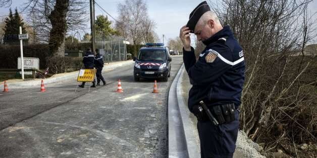 A French gendarme stands as the road is close in Avallon on March 11, 2015 after a group of 'battle-hardened' armed thieves attacked two heavily guarded vans carrying jewels at the Avallon French motorway toll in the dead of night, making off with a haul worth some nine million euros ($11 million), police said. The vans were found burnt and abandoned in a field not far from the toll station, and it was as yet unclear exactly how the assault unfolded.AFP PHOTO / JEFF PACHOUD (Photo credit should read JEFF PACHOUD/AFP/Getty Images)