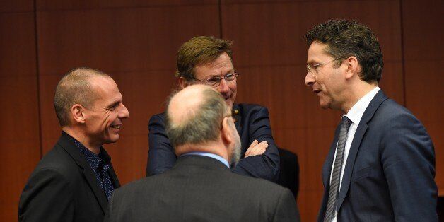 Eurogroup President and Dutch Finance Minister Jeroen Dijsselbloem (R) speaks with Greece's Finance Minister Yanis Varoufakis (L) as Belgium's Finance Minister Johan Van Overtveldt (C back) during a Eurogroup finance ministers meeting at the European Council in Brussels, March 9, 2015. AFP PHOTO / EMMANUEL DUNAND (Photo credit should read EMMANUEL DUNAND/AFP/Getty Images)
