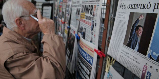 An Athenian reads newspapers featuring front page stories and photos of Alexis Tsipras, leader of Greece's Syriza left-wing main opposition party's win on Sunday's national elections, on a kiosk in central Athens, in Athens, Monday, Jan. 26, 2015. Greece's Syriza party gained the key backing needed to form a government Monday, creating a surprise alliance with the Independend Greeks, a small right-wing party that signals possible confrontation over the country's bailout. Although the alliance between two ideologically opposed parties who share only their opposition to the bailout was a surprise, it nevertheless boosted stock markets across Europe that had fallen on news of the uncertain election results and fear of a second election. (AP Photo/Lefteris Pitarakis)