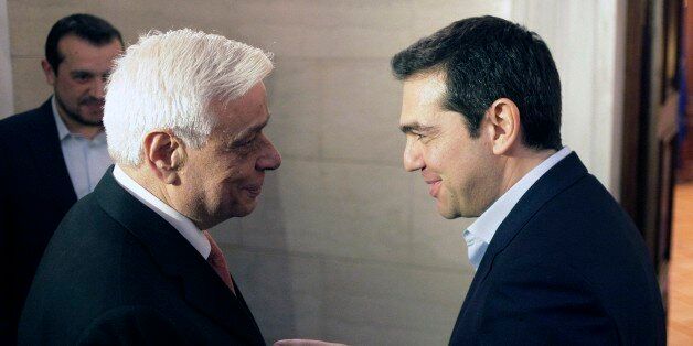 Greece's Prime Minister Alexis Tsipras, right, welcomes conservative former interior minister Prokopis Pavlopoulos at Maximos Mansion in Athens, Tuesday, Feb. 17, 2015. Pavlopoulos, 64, on whose watch authorities failed to contain Greece's worst riots in decades, was named Tuesday as the government-backed candidate for the ceremonial position of Greek president. Pavlopoulos, law professor, must be approved by Parliament, in a special process that can take up to three votes. (AP Photo/Eurokinissi, Giorgos Kontarinis) GREECE OUT