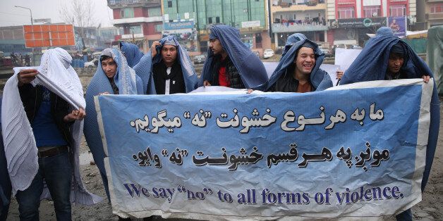Male civil society members wear burqas to protest violence against women, ahead of International Women's Day, in Kabul, Afghanistan, Thursday, March 5, 2015. (AP Photo/Massoud Hossaini)