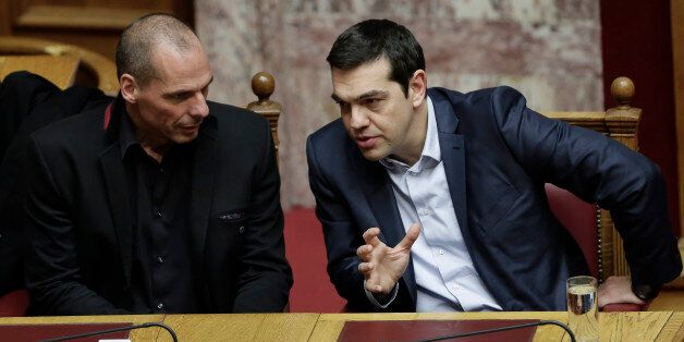 Greece's Prime Minister Alexis Tsipras, right, and Finance Minister Yanis Varoufakis talk during a Presidential vote in Athens, on Wednesday, Feb. 18, 2015. Greece's parliament elected a conservative law professor and veteran politician Wednesday as the country's new president, after he received support from the new left-wing government and main center-right opposition party. (AP Photo/Petros Giannakouris)