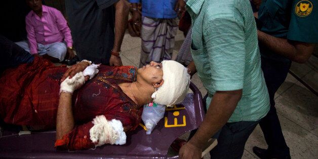 In this Thursday, Feb. 26, 2015, photo , Rafida Ahmed, wife of a prominent Bangladeshi-American blogger, Avijit Raoy is being rushed to hospital on a stretcher after she was seriously injured by unidentified attackers, in Dhaka, Bangladesh. Roy, who was known for speaking out against religious fundamentalism was hacked to death in the streets of Bangladesh's capital as he walked with his wife, police said Friday. (AP Photo/Rajib Dhar)
