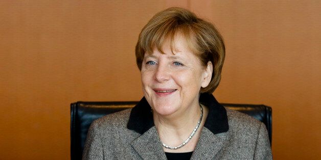 German Chancellor Angela Merkel smiles as she leads the weekly cabinet meeting of her government at the chancellery in Berlin, Germany, Wednesday, Feb. 25, 2015. (AP Photo/Markus Schreiber)