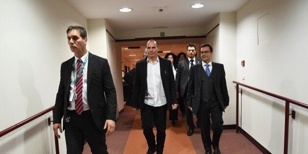 Greek Finance Minister Yanis Varoufakis (C) arrives to hold a press conference after an Eurogroup finance ministers meeting at the European Council headquarters in Brussels, February 20, 2015. Greece will prioritise EU-acceptable reforms, a government source said after eurozone finance ministers granted Athens a four-month loan extension. AFP PHOTO/Emmanuel Dunand (Photo credit should read EMMANUEL DUNAND/AFP/Getty Images)