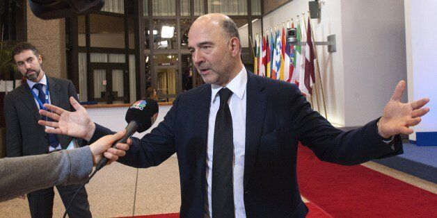 European Commissioner for Economic and Financial Affairs, Taxation and Customs Pierre Moscovici talks to the press prior to the delayed start of an emergency Eurogroup finance ministers meeting at the European Council in Brussels, February 20, 2015. Last minute wrangling delayed a make or break eurozone meeting on February 20 as Greece's demand for a radical easing of its bailout program ran into German-led opposition to easing its austerity commitments. After days of sharp exchanges, the 19 eurozone finance ministers were gathered for the third time in little over a week to consider Athens' take-it or leave-it proposal to extend an EU loan program, which expires this month. AFP PHOTO / JOHN THYS (Photo credit should read JOHN THYS/AFP/Getty Images)