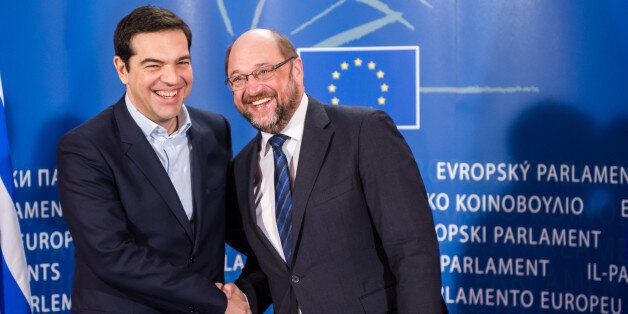 European Parliament President Martin Schulz, right, welcomes Greece's Prime Minister Alexis Tsipras upon his arrival at the European Parliament in Brussels on Wednesday, Feb. 4, 2015. Tsipras is on a one day trip to Brussels to meet with EU leaders.(AP Photo/Geert Vanden Wijngaert)