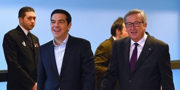 European Commission President Jean-Claude Juncker (R) escorts Greek Prime Minister Alexis Tsipras at European Commission headquarters in Brussels on February 4, 2015. The euro held its gains on February 4 after a surge driven by growing optimism that Greece will hammer out a debt deal and avoid a possible default. AFP PHOTO / EMMANUEL DUNAND (Photo credit should read EMMANUEL DUNAND/AFP/Getty Images)