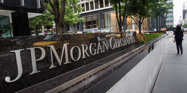 NEW YORK, NY - AUGUST 12: A woman walks past JP Morgan Chase's corporate headquarters on August 12, 2014 in New York City. U.S. banks announced second quarter profits of more than $40 billion, showing strong signs of a recovering economy. (Photo by Andrew Burton/Getty Images)