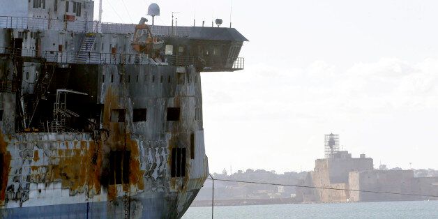 A detail of the Norman Atlantic ferry as it is being towed into the port of Brindisi, Italy, Friday, Jan. 2, 2015. The blaze that broke out Sunday and torched the ferry has killed at least 11 people and authorities prepared to search it for possible more dead. Italy says 477 people were rescued, most by helicopters that plucked survivors off the top deck in gale-force winds and carried them to nearby boats. (AP Photo/Antonio Calanni)