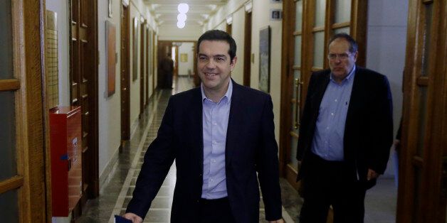 Greece's Prime Minister Alexis Tsipras arrives for an inner meeting at the parliament in Athens on Tuesday, Feb. 24, 2015. Caught between its campaign pledges and pressure from creditors, Greece's left-wing Syriza government delivered the list on the cusp of Monday night's deadline. The government was asked to present a list last Friday at a meeting of the 19 finance ministers of the eurozone so its bailout request could be met. (AP Photo/Thanassis Stavrakis)