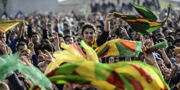 Kurdish people attend a celebration rally near the Turkish-Syrian border at Suruc, in Sanliurfa province on January 27, 2015. Kurdish fighters have expelled Islamic State group militants from the Syrian border town of Kobane, a monitor and spokesman said today, dealing a key symbolic blow to the jihadists' ambitions. AFP PHOTO/BULENT KILIC (Photo credit should read BULENT KILIC/AFP/Getty Images)