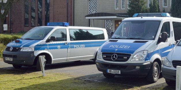 Police cars stand in front of the synagogue in Bremen, Germany, Saturday Feb. 28, 2015. Police in the German city of Bremen are warning of a potential danger from Islamic extremists there and say they are stepping up security measures. A police statement said that officials received tips about activities of potentially dangerous Islamic extremists from a German federal authority on Friday evening. Saturday's statement said that police in the northwestern city are responding