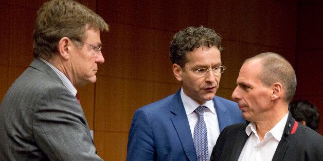 Greek Finance Minister Yanis Varoufakis, right, speaks with Dutch Finance Minister Jeroen Dijsselbloem, center, and Belgium's Finance Minister Johan Van Overtveldt, left, during a round table meeting of eurogroup finance ministers in Brussels on Friday, Feb. 20, 2015. Eurozone finance ministers meet for a crucial day of talks Friday to see whether a Greek debt relief proposal is acceptable to Germany and other nations using the common currency. (AP Photo/Virginia Mayo)