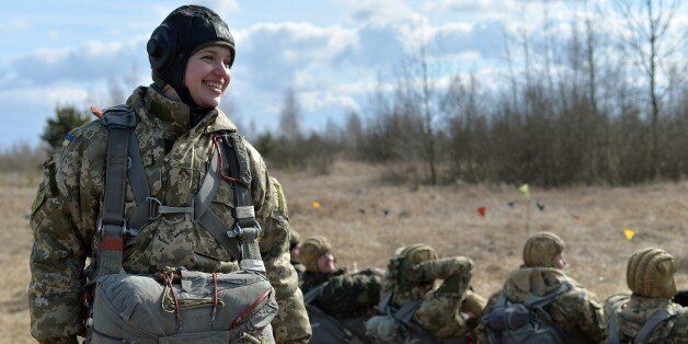 A Ukrainian paratrooper shares a laugh with comrades during military drills in the Zhytomyr region, some 150 kms from Kiev, on March 6, 2015. Western powers said new sanctions against Moscow could quickly follow any foul play in the ceasefire in eastern Ukraine, where Kiev reported pulling back more hardware from the frontline. AFP PHOTO / GENYA SVILOV (Photo credit should read GENYA SAVILOV/AFP/Getty Images)
