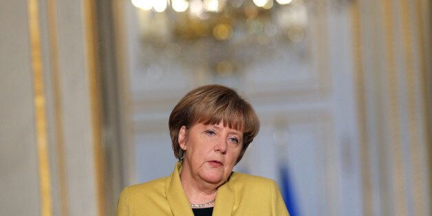 German Chancellor Angela Merkel gives a press conference after her meeting at the Elysee Palace with France's President Francois Hollande, in Paris, Friday, Feb. 20, 2015. Merkel says there needs to be a