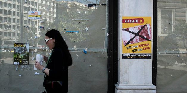 A woman passes outside a closed shop as a poster reads in Greek '' yes to work, no to the euro'' in Athens, Wednesday, April 10, 2013. The European Union's statistics agency, Eurostat, on Wednesday said that labor costs had sunk 11.2 percent in recession-hit Greece between 2008 and 2012, compared to the eurozone average increase of 8.7 percent. (AP Photo/Petros Giannakouris)