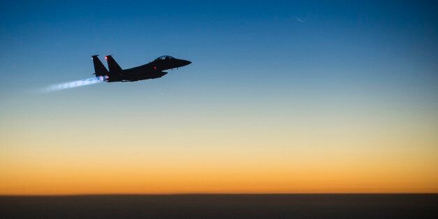 In this Tuesday, Sept. 23, 2014 photo, released by the U.S. Air Force, a U.S. F-15E Strike Eagle flies over northern Iraq, after conducting airstrikes in Syria. U.S.-led coalition warplanes bombed oil installations and other facilities in territory controlled by Islamic State militants in eastern Syria on Friday, Sept. 26, 2014, taking aim for a second consecutive day at a key source of financing that has swelled the extremist group's coffers, activists said. (AP Photo/U.S. Air Force, Matthew Br