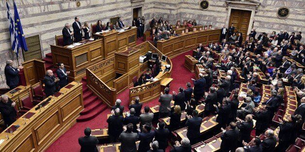 Greek lawmakers applaud at the end of the vote for a president at the Greek parliament in Athens, on February 18, 2015. Greece's parliament on Wednesday elected pro-European conservative Prokopis Pavlopoulos as the country's new president, a move calculated to bolster the hard-left government in its critical EU bailout talks. AFP PHOTO / LOUISA GOULIAMAKI (Photo credit should read LOUISA GOULIAMAKI/AFP/Getty Images)