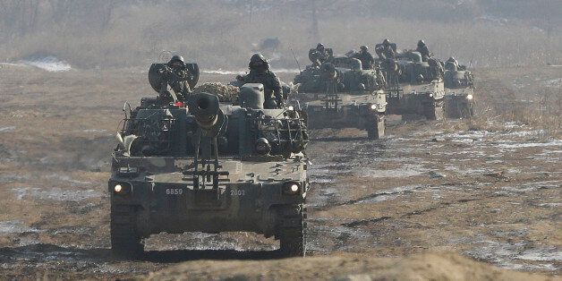 South Korean army K-55 self-propelled artillery vehicles move during a military exercise near the demilitarized zone between the two Koreas in Paju, South Korea, Sunday, Jan. 11, 2015. North Korea has told the United States that it is willing to impose a temporary moratorium on its nuclear tests if Washington scraps planned military drills with South Korea this year, the North's official news agency said Saturday. (AP Photo/Ahn Young-joon)