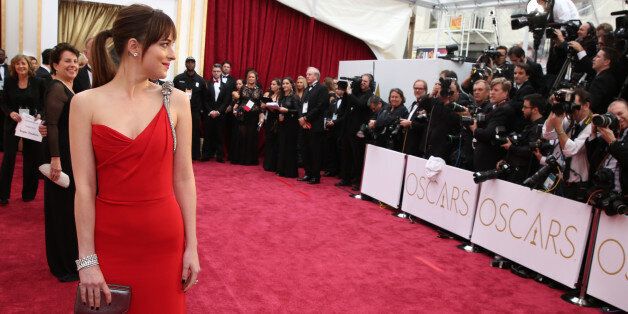 Dakota Johnson arrives at the Oscars on Sunday, Feb. 22, 2015, at the Dolby Theatre in Los Angeles. (Photo by Matt Sayles/Invision/AP)