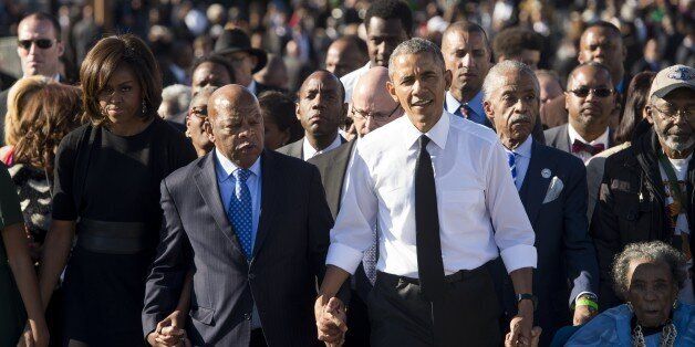 US President Barack Obama walks alongside Amelia Boynton Robinson (R), one of the original marchers, the Reverend Al Sharpton (2nd R), First Lady Michelle Obama (L), and US Representative John Lewis (2nd-L), Democrat of Georgia, and also one of the original marchers, across the Edmund Pettus Bridge to mark the 50th Anniversary of the Selma to Montgomery civil rights marches in Selma, Alabama, March 7, 2015. The event commemorates Bloody Sunday, when civil rights marchers attempting to walk to th