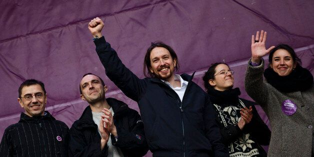 Pablo Iglesias, center, leader of Spanish Podemos (We Can) left-wing party, raises his fist on the stage before giving a speech to his supporters gathering at the main square of Madrid during a Podemos (We Can) party march in Madrid, Spain, Saturday, Jan. 31, 2015. Tens of thousands of people, possibly more, are marching through Madridâs streets in a powerful show of strength by Spainâs fledgling radical leftist party Podemos (We Can) which hopes to emulate the electoral success of Greeceâs Syriza party in elections later this year. Supporters from across Spain converged onto Cibeles fountain before packing the avenue leading to Puerta del Sol square. Podemos aims to shatter the countryâs predominantly two-party system and the âMarch for Changeâ gathered crowds in the same place where sit-in protests against political and financial corruption laid the partyâs foundations in 2011. (AP Photo/Daniel Ochoa de Olza)
